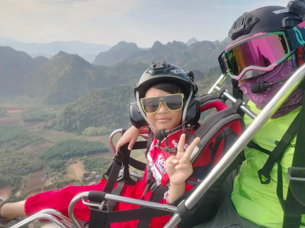 pilot king with Tangyur,his 10-yr-old-son paramotoring over vang vieng pilot king with Tangyur,his 10-yr-old-son paramotoring over vang vieng